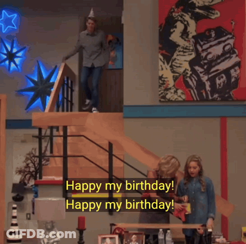 A Man Wearing A Party Hat Is Walking Down A Set Of Stairs And Says " Watch Out Watch Out For What " GIF