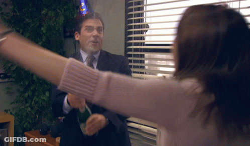 A Man Wearing A Party Hat Throws A Bottle Of Champagne At A Woman GIF