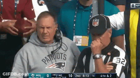 A Man Wearing A Patriots Sweatshirt Is Covering His Nose GIF