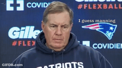 A Man Wearing A Patriots Sweatshirt Stands In Front Of A Gillette Advertisement GIF