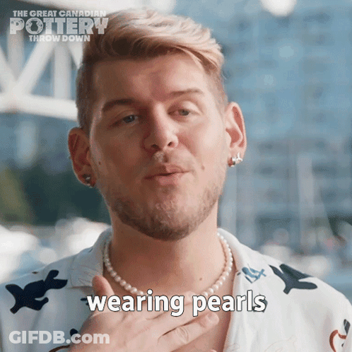 A Man Wearing A Pearl Necklace With The Words Wearing Pearls Written On It GIF
