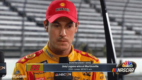 A Man Wearing A Pennzoil Hat Is Talking To A Reporter GIF