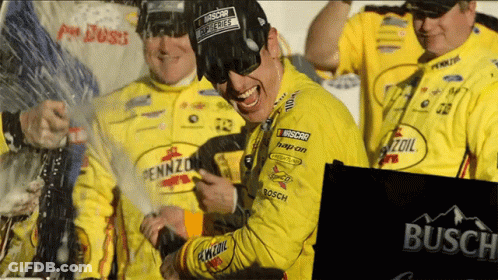 A Man Wearing A Pennzoil Shirt Celebrates With His Team GIF
