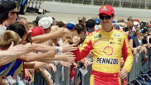 A Man Wearing A Pennzoil Shirt Is Surrounded By Fans GIF