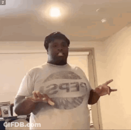 A Man Wearing A Pepsi T-Shirt Is Standing In A Room GIF