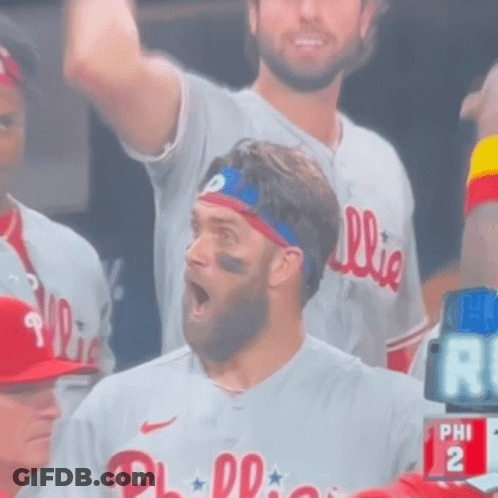 A Man Wearing A Phillies Jersey Stands In The Stands GIF