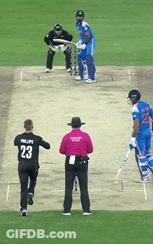 A Man Wearing A Phillips 23 Jersey Is Running Towards A Cricket Player GIF
