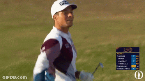 A Man Wearing A Ping Hat And A Cisco Sweater Stands In A Field GIF