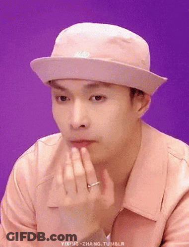 Man In Pink Hat And Jacket Holding Chin GIF