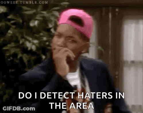 A Man Wearing A Pink Hat And A Suit Says Do I Detect Haters In The Area GIF