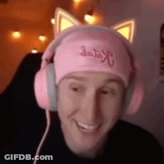 A Man Wearing A Pink Hat And Pink Headphones Is Smiling . GIF