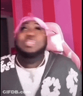 A Man Wearing A Pink Hat Is Sitting In A Pink Chair And Making A Funny Face . GIF