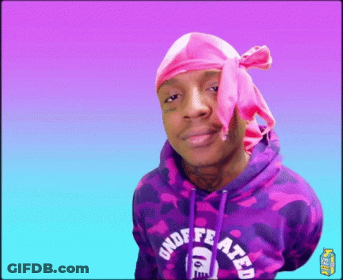 A Man Wearing A Pink Headband And A Purple Hoodie With The Word Undefeated On It GIF