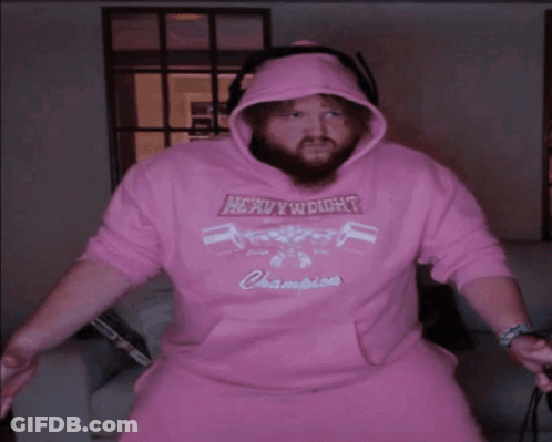 A Man Wearing A Pink Hoodie That Says Heavyweight Champions On It GIF