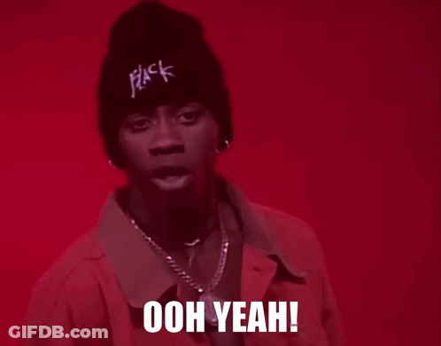 A Man Wearing A Pink Jacket And A Black Beanie Is Saying Ooh Yeah GIF
