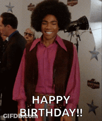 A Man Wearing A Pink Shirt And A Brown Vest Is Smiling And Says Happy Birthday GIF