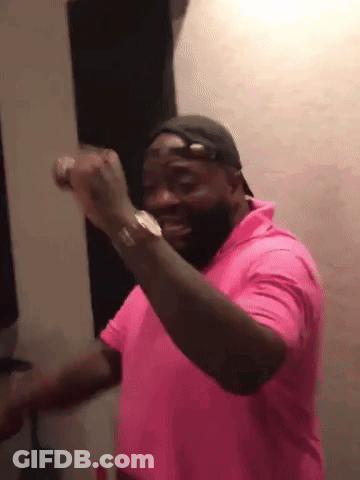 A Man Wearing A Pink Shirt And A Hat Is Dancing . GIF