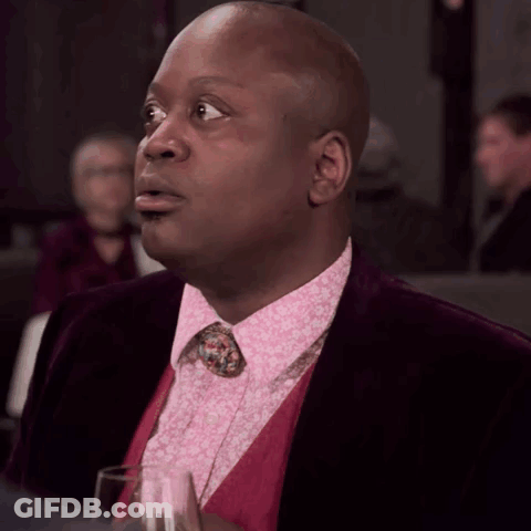 A Man Wearing A Pink Shirt And A Purple Jacket GIF