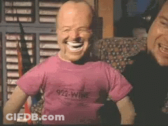 A Man Wearing A Pink Shirt That Says 912 Wine GIF