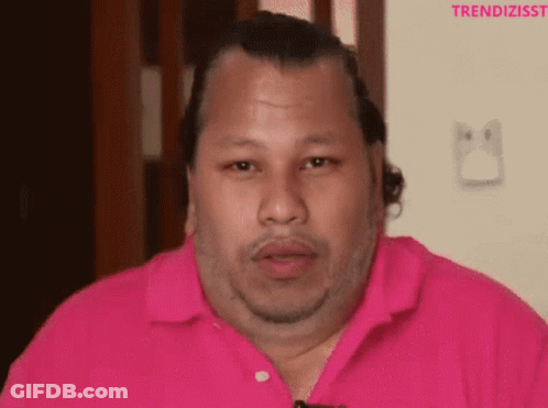 A Man Wearing A Pink Shirt With The Word Trendizisst On The Bottom Right GIF