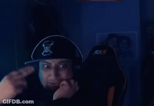 A Man Wearing A Pirate Hat And Headphones Is Sitting In A Chair And Giving A Thumbs Up . GIF