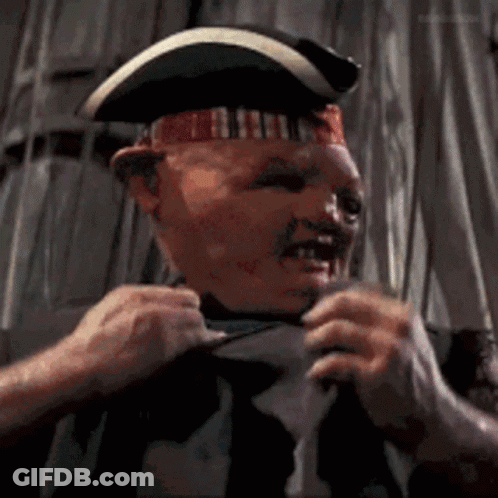 A Man Wearing A Pirate Hat Is Pulling His Shirt Up GIF