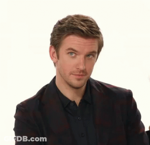 A Man Wearing A Plaid Jacket And A Black Shirt Is Making A Funny Face GIF