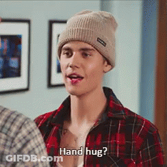 A Man Wearing A Plaid Shirt And A Beanie Is Asking For A Hand Hug GIF