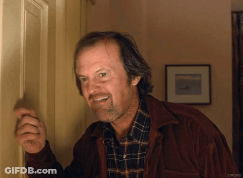 A Man Wearing A Plaid Shirt And A Brown Jacket Is Smiling GIF