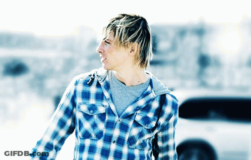 A Man Wearing A Plaid Shirt And A Grey T-Shirt GIF
