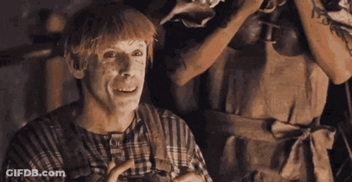 A Man Wearing A Plaid Shirt And Apron Is Laughing GIF