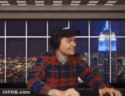 A Man Wearing A Plaid Shirt Is Giving The Middle Finger GIF