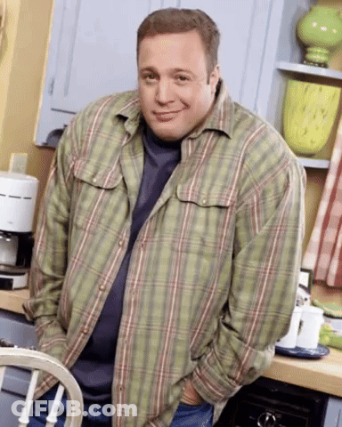 A Man Wearing A Plaid Shirt Is Standing In A Kitchen GIF