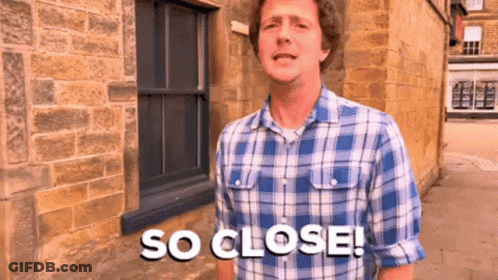 A Man Wearing A Plaid Shirt Says So Close GIF