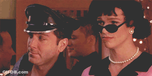 A Man Wearing A Police Hat And A Woman Wearing Sunglasses GIF