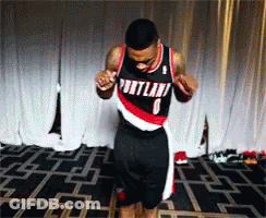 A Man Wearing A Portland Jersey Is Dancing On A Stage GIF