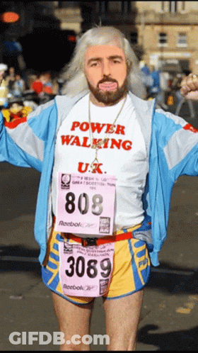 A Man Wearing A Power Walking Shirt And Reebok Shorts GIF