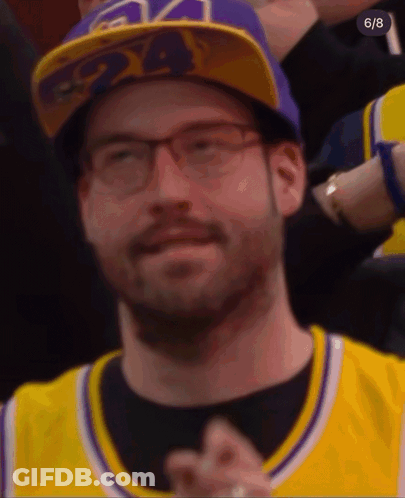 A Man Wearing A Purple 24 Hat And Glasses GIF