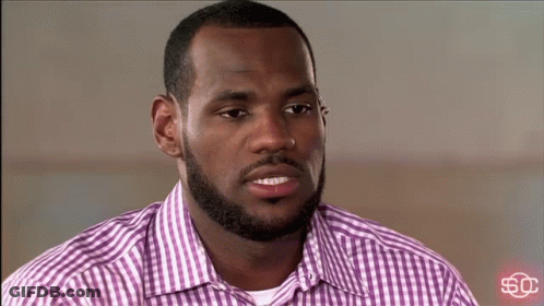 A Man Wearing A Purple And White Plaid Shirt With A Sc Logo In The Corner GIF