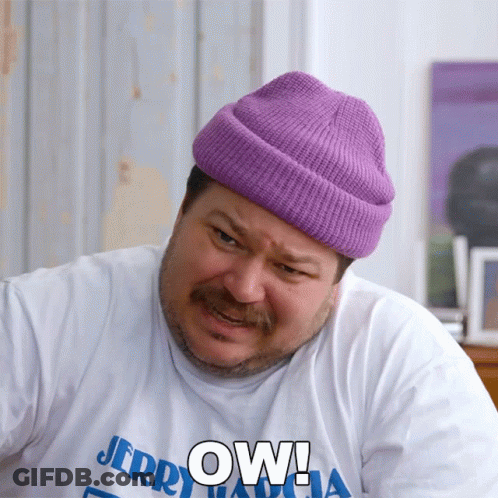 A Man Wearing A Purple Beanie And A White Shirt That Says Jerry GIF