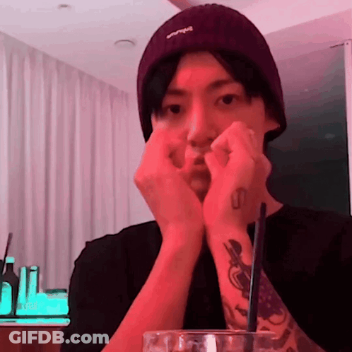 A Man Wearing A Purple Beanie Has A Tattoo On His Left Wrist GIF