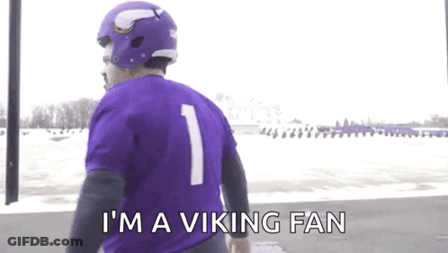 A Man Wearing A Purple Jersey And A Purple Helmet Says `` I 'M A Viking Fan '' GIF