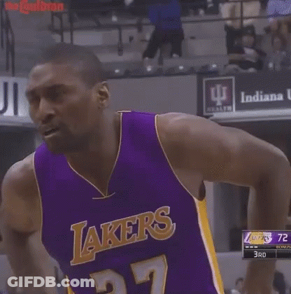 A Man Wearing A Purple Lakers Jersey Is Standing On A Court . GIF