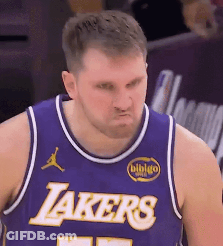 A Man Wearing A Purple Lakers Jersey Makes A Face GIF