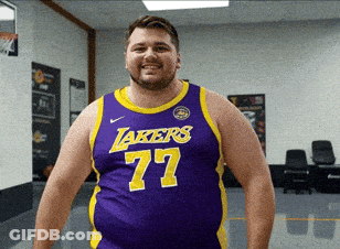 A Man Wearing A Purple Lakers Jersey With The Number 77 On It GIF