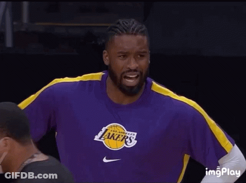A Man Wearing A Purple Lakers Shirt Smiles GIF
