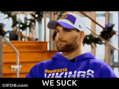 A Man Wearing A Purple Minnesota Vikings Sweatshirt And Hat GIF