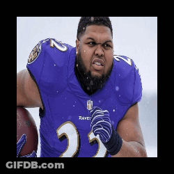 A Man Wearing A Purple Ravens Jersey Is Holding A Football GIF