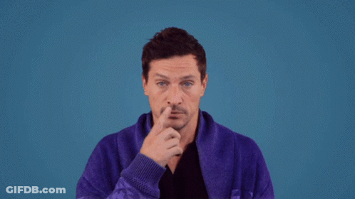 A Man Wearing A Purple Robe Is Holding His Nose GIF