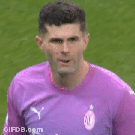 A Man Wearing A Purple Shirt That Says Fly Emirates Looks At The Camera GIF